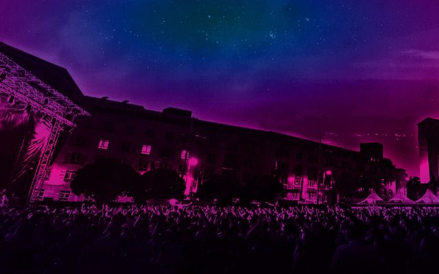 A stage in the middle of a square in a city.