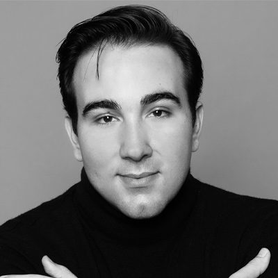 A man wearing a dark polo-neck top looking at the camera