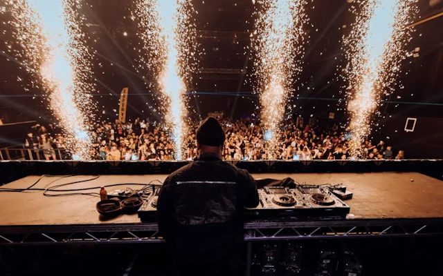 A man DJing from behind.