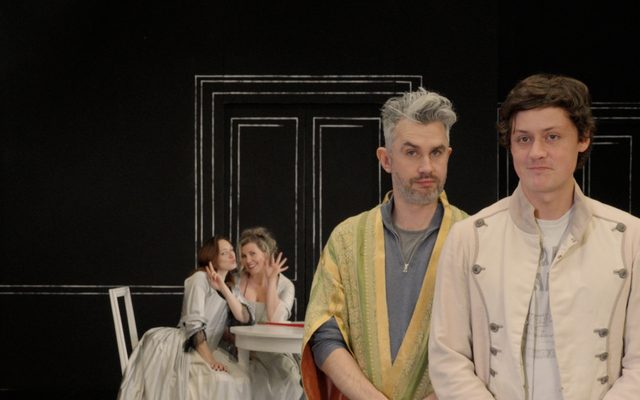Two men in costume stand looking to camera during rehearsals for Mozart's Cosi fan tutte