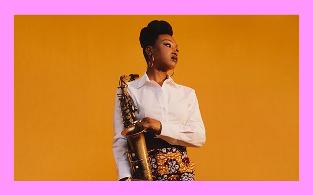 A woman holding a saxophone