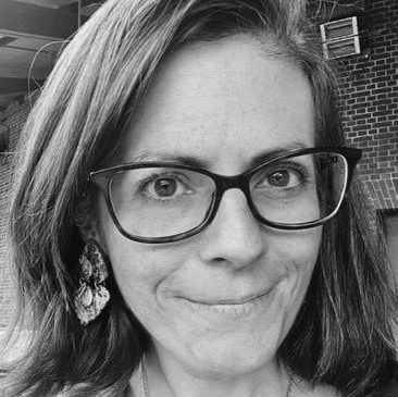 A woman wearing black-framed glasses