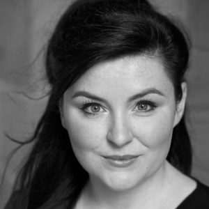Charlie Drummond A woman with long dark hair looking into the camera.