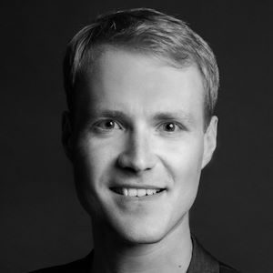 A man with short hair and a shirt.