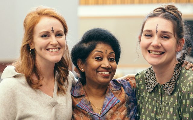 Three people smiling at the camera.