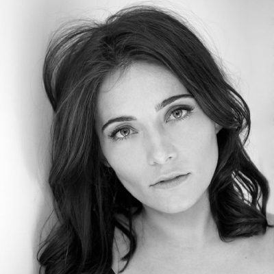 A woman with long, dark hair.
