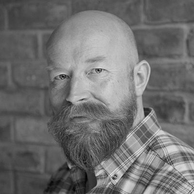 A bald man with a beard.