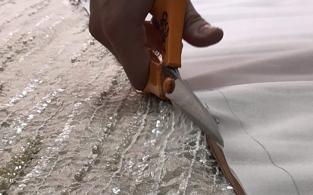 Cutting the fabric for Tosca's Act II costume © Opera North
