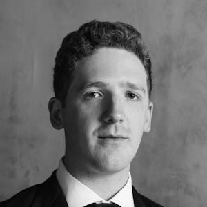 A man wiht short hair in a tuxedo