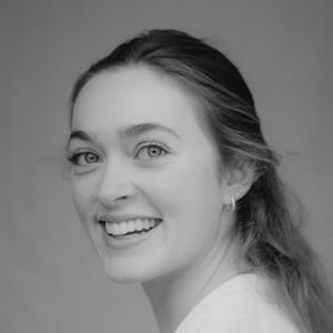 A woman with long hair smiling.