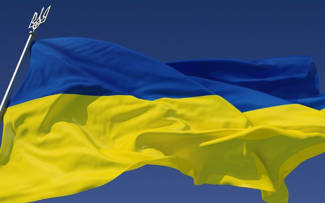 The flag of Ukraine blowing in the breeze.