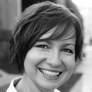 A woman with short hair smiling,