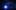 LED lights hang from the ceiling in a dark room with a blue spotlight in the distance