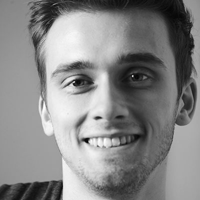 A man with short hair smiling at the camera.