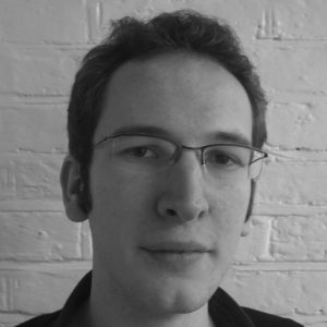 A man with short hair and glasses.