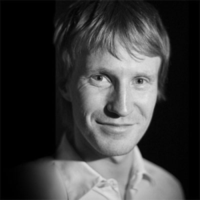 A man with short hair wearing a shirt.