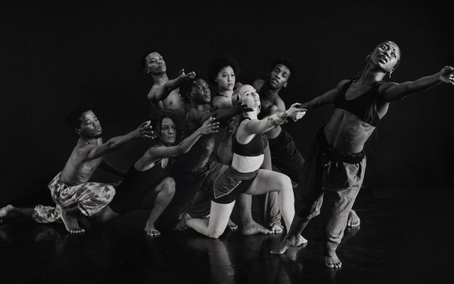 A group of dancer leaning out towards the top right of the frame.