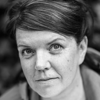 A woman with brown hair tied behind her head.