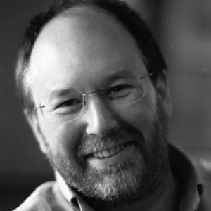 A man with glasses and a short beard.