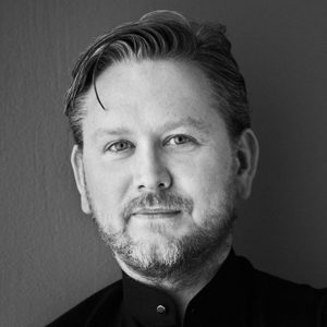 A man with a short hair and beard.