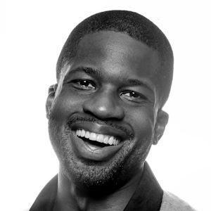 A smiling man with short hair.