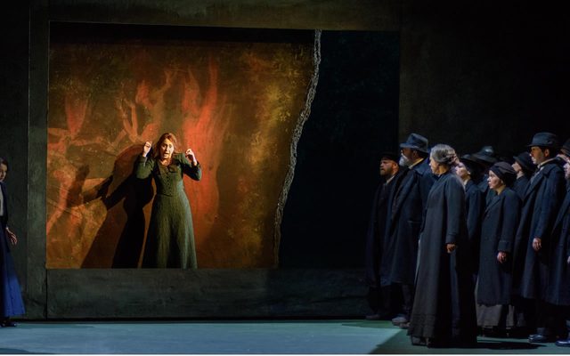 Andrew Kennedy as Tichon, Katie Bray as Varvara, Stephanie Corley as Katya, Nicholas Butterfield as Kuligin, Stephen Richardson as Dikoy and Heather Shipp as Kabanicha with members of the Chorus of Opera North © Jane Hobson
