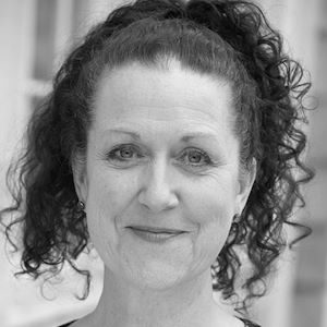 A woman with dark curly hair.