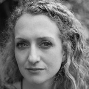 A woman with long curly hair.