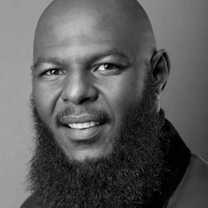 A bald man with a large beard.