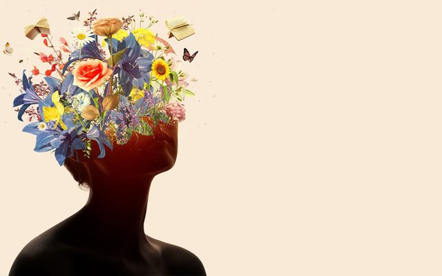 An women's silhouette - the top of her head becomes flowers.