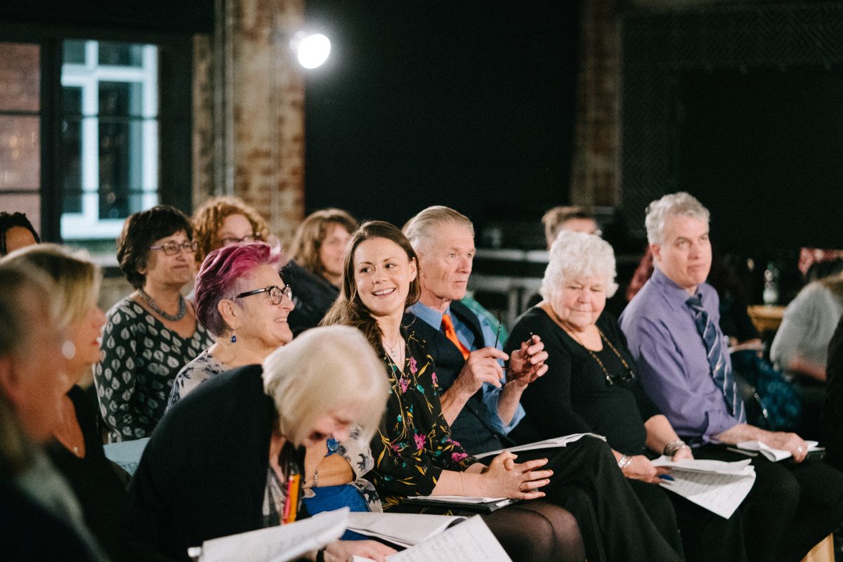 A group of people sitting down and exploring music together at Headrow House in Leeds