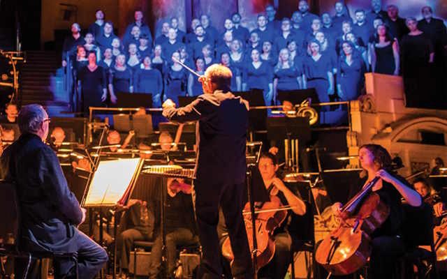 The Opera North orchestra performing Simon Boccanegra, as the conductor conducts them