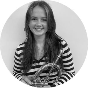 A young woman holding a flugelhorn.