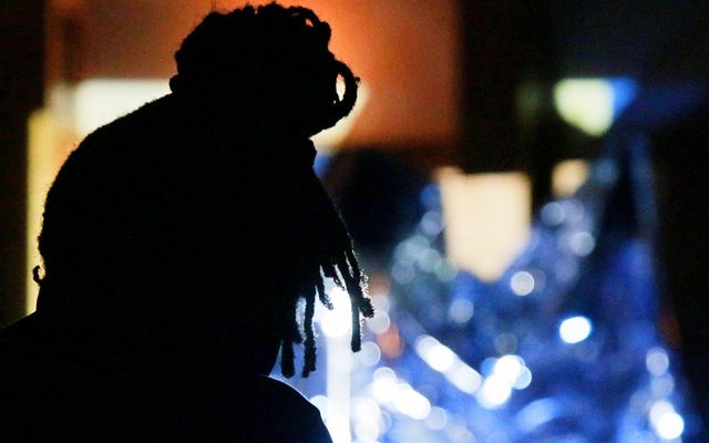Zimbabwean singer Thabo silhouetted in front of glowing blue visuals during his Resonance residency © Opera North