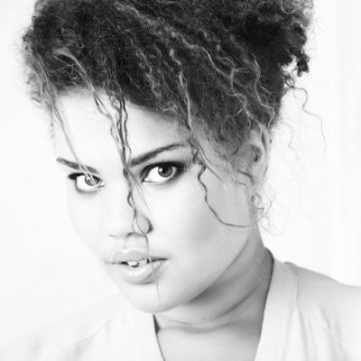 Simone-Ibbett-Brown-400x400px A woman with dark eyes looking into the camera.