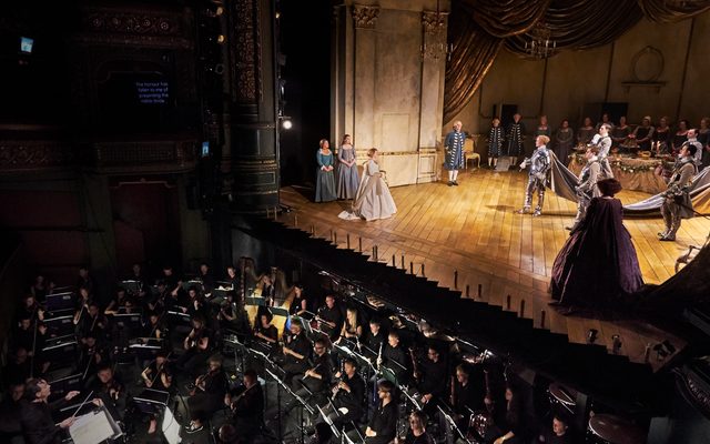 A photo of the stage at a theatre as well as the orchestra pit.