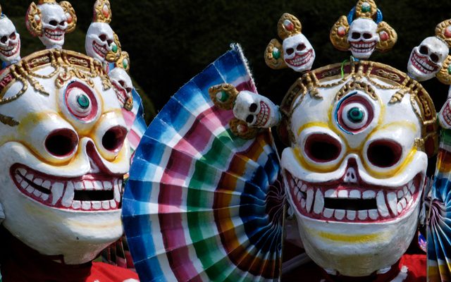 Two very colourful skull shaped masks.