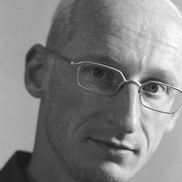 A bald man wearing glasses.