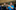 Two teenage boys play trumpets surrounded by the acoustic panelling of a music studio