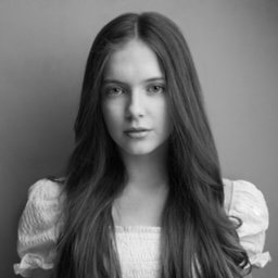 Agatha-Meehan A girl with long brown hair in a dress.