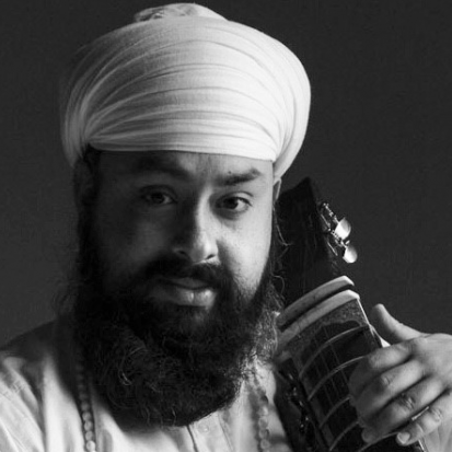 Kirpal-Singh-Panesar A man with a beard and wearing a turban. He is holding a Tar-Shehnai against his shoulder.