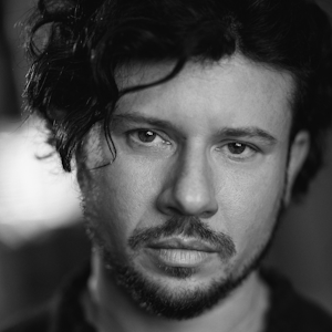 Mark Burghagen 300 x300 A man with long curly hair.