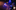 Man performs on stage with atmospheric lighting