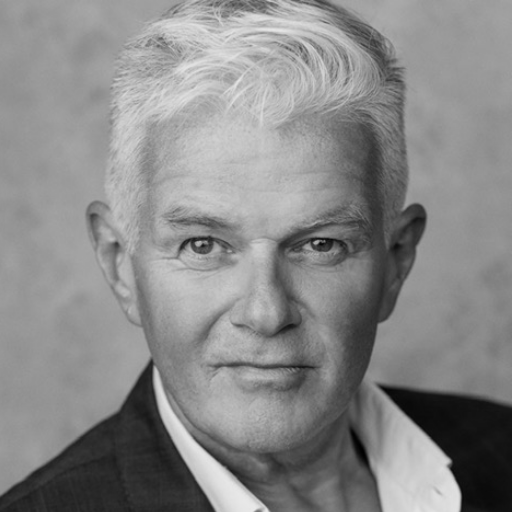 Scott-Davies A man with short white hair wearing a suit jacket and a white shirt.