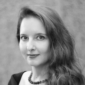 A woman with long hair and a necklace.