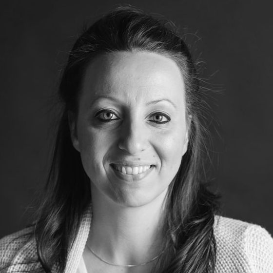 A woman with long dark hair looking into the camera.